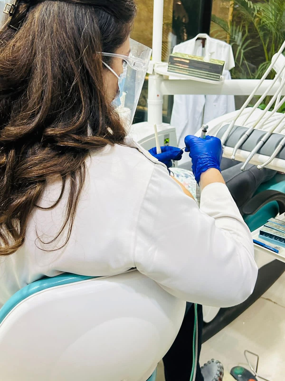 A clinician at Dental Brasstacks Gurgaon performing calm, painless chairside treatment