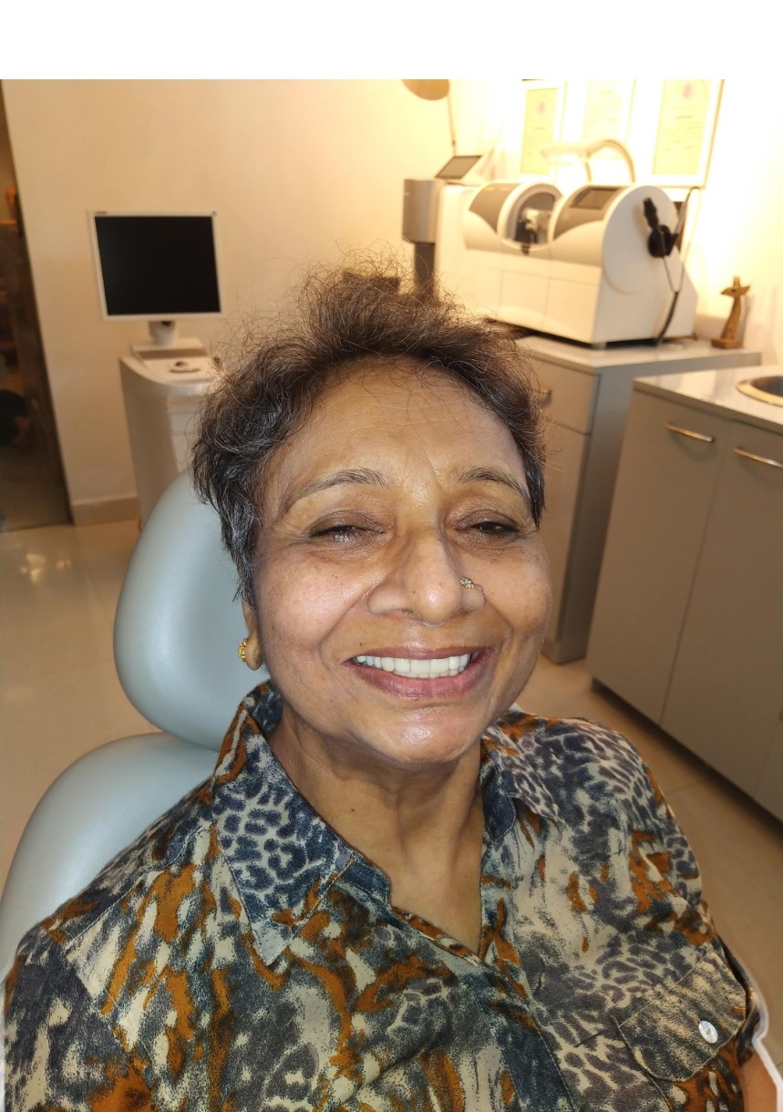 Smiling Dental Brasstacks patient seated in the treatment room after care.